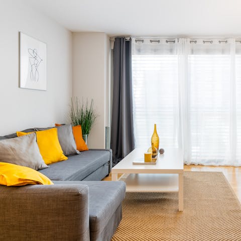Relax in the light-filled living area with a glass of Spanish wine after a busy day of touring the city
