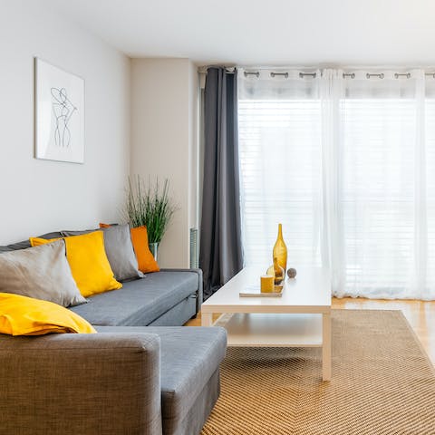 Relax in the light-filled living area with a glass of Spanish wine after a busy day of touring the city