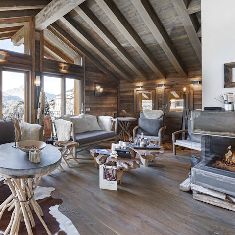 Convene in the cozy living room and drink coffee by the fire