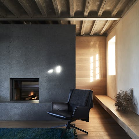 Curl up around the fire in this grey-hued renovated space