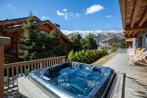 Steam in the hot tub with snow-capped peaks all around