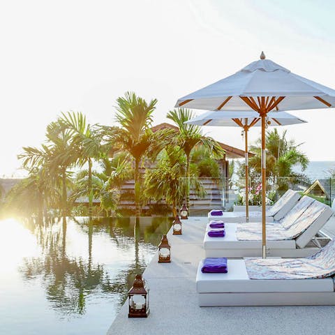 Lounge by the pool, cool drink in hand and glorious views all around you