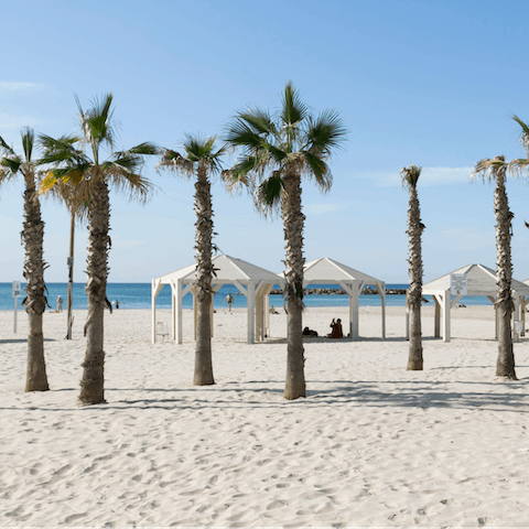 Relax on Trumpeldor Beach, a short stroll from your doorstep