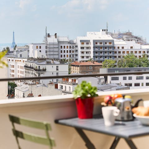 Enjoy breakfast croissants on the private balcony with views of the Eiffel Tower