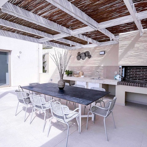 Dine under the pergola as the Cretan sky turns gold at sunset