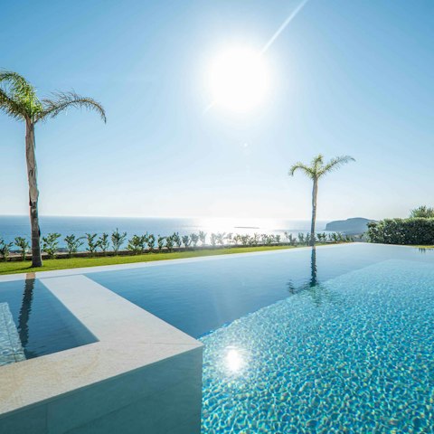 Soak up uninterrupted sea and mountain views from your private hillside pool
