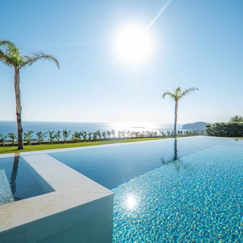 Soak up uninterrupted sea and mountain views from your private hillside pool