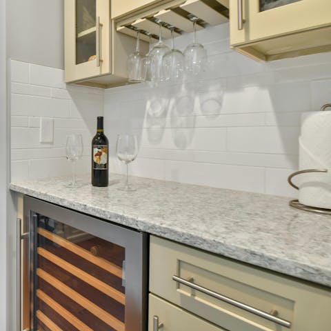 Shake up evening cocktails at the bar with a built-in wine fridge