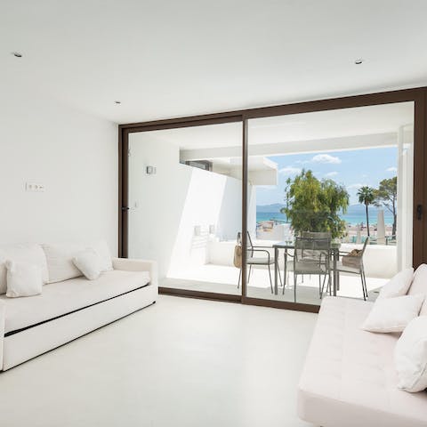 Relax in the bright, minimalist living space after a fun day at the beach