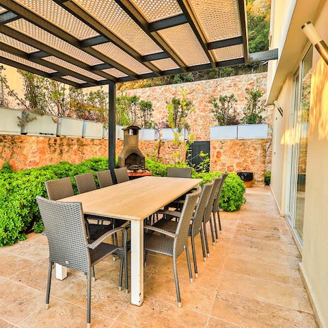 Share plates of lamb kofta and stuffed pine leaves on the outdoor dining table