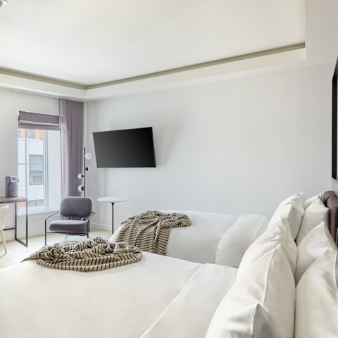 Snuggle up and enjoy a movie in bed with the perfectly-placed wall TV