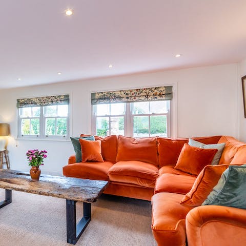 Recline on the plump sherbet orange sofa with a glass of your favourite tipple