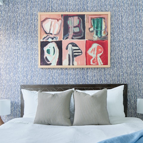 Relax in the comfy bedroom with its modern art prints after a busy day in Minneapolis