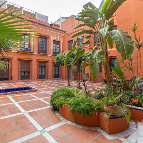 Admire the communal courtyard's traditional Sevillian architecture