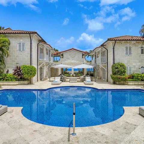 Splash about in the home's swimming pool before dozing off on a daybed