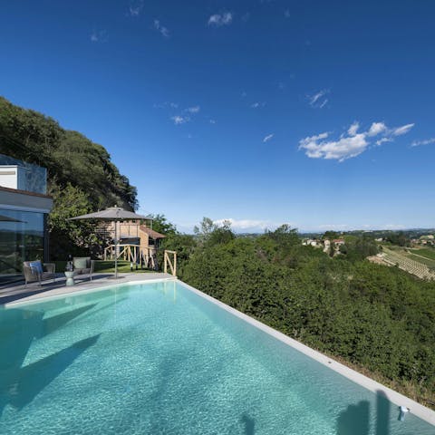 Enjoy a dip in the infinity pool with a view of the hills