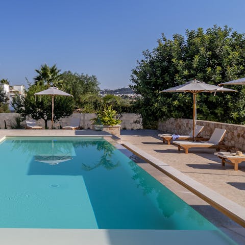 Lounge by the pool with peaceful countryside views.