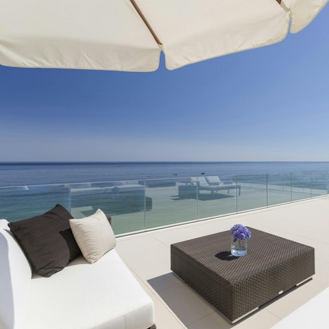 Enjoy the ocean breeze as you unwind on the terrace