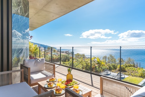 Take breakfast on the balcony as palm trees stretch to the sea