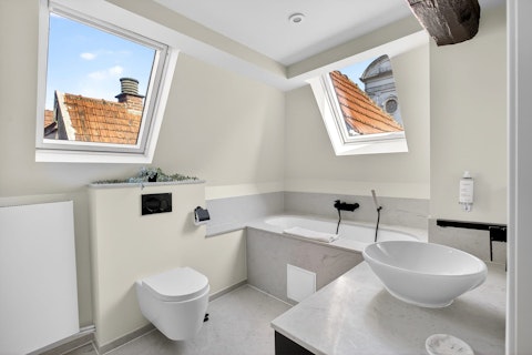 Bathe beneath skylights that open to a sweep of medieval rooftops