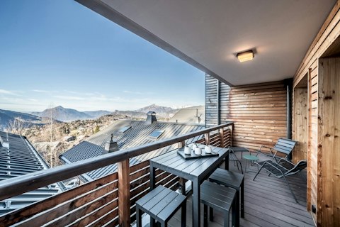 Unwind on the timber deck as mountain panoramas stretch before you