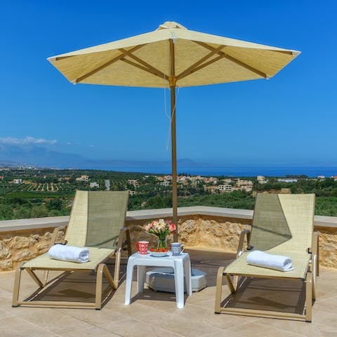 Savour a glass of Greek wine by the outdoor pool