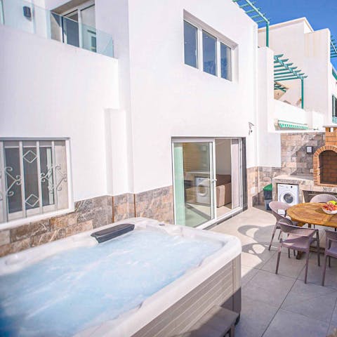 Unwind in the hot tub after a day on the beach