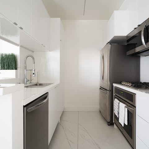 Knock up a lazy brunch in the sleek kitchen with marble floors
