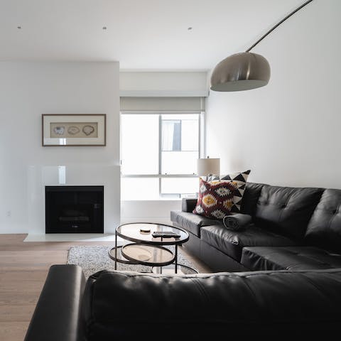 Cosy up around the working gas fireplace in the modern living room