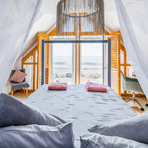 Wake up in the four-poster bed to the sound of the waves lapping the shore