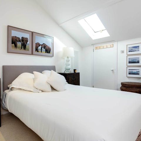 Fall asleep to the glowing moon shining through the master bedroom's skylight