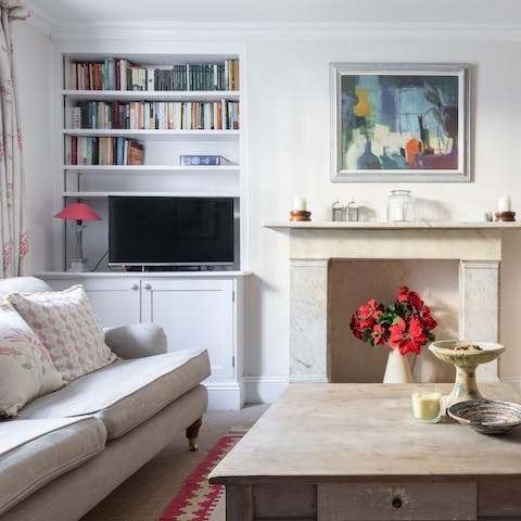 Curl up on the sofa with a book from the host's collection
