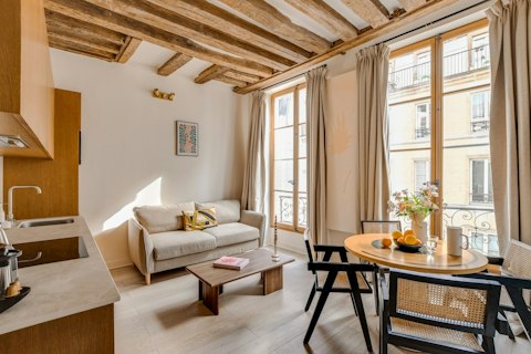 Relax beneath original timber beams in warm Parisian light