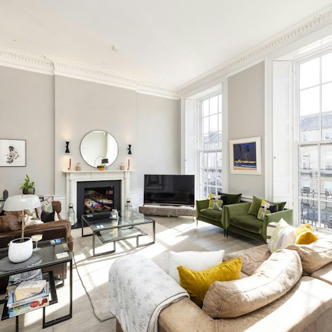 Relax in the airy living room, with plenty of seating for friends or family