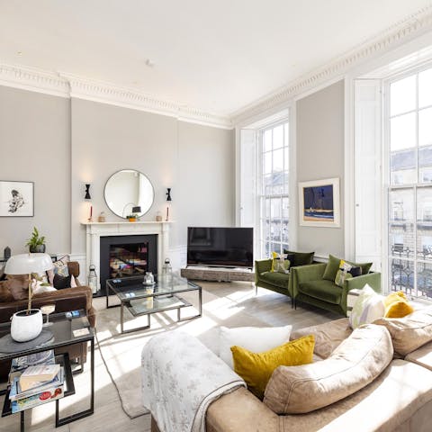 Relax in the airy living room, with plenty of seating for friends or family