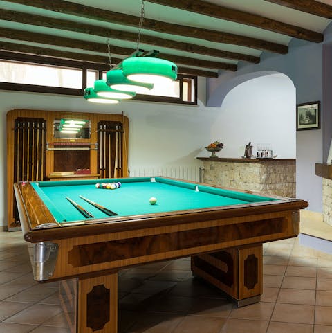Mix a drink at the bar and have a game of billiards