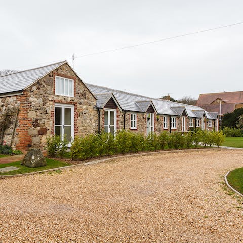 Roll up to the vast driveway and admire the barn-like exterior the home