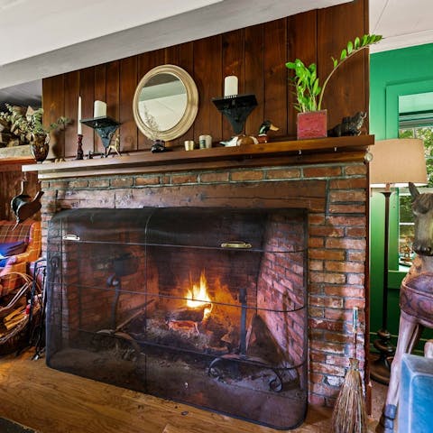 Cosy up in front of the grand fireplace in the living room