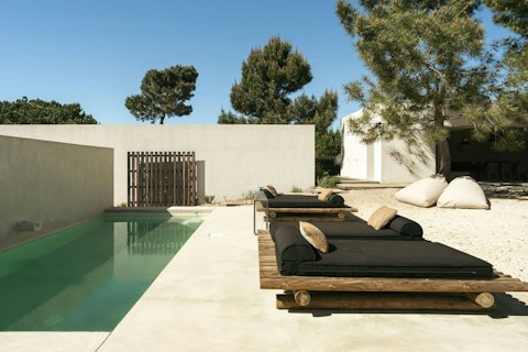 Stretch out on the sun loungers beside the pool, book in hand