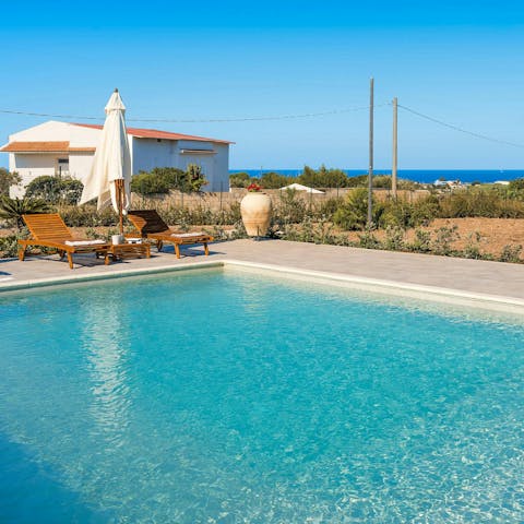 Lounge by the pool with views across the sea