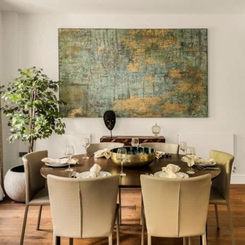 Gather round the dining table beneath gallery-worthy artwork