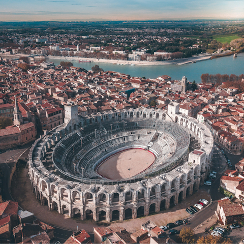 Visit the Roman amphitheatre in Arles, a half-hour drive away