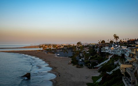 Swim or sunbathe on Corona del Mar Beach's pristine shoreline, a thirteen-minute walk