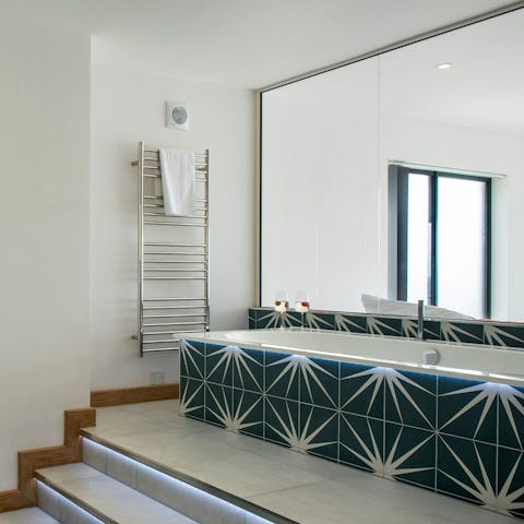 Climb the steps to the main bedroom's impressive bathtub
