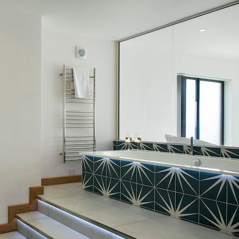 Climb the steps to the main bedroom's impressive bathtub