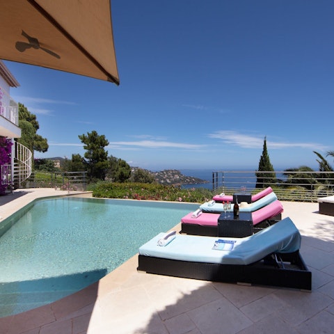 Relax by the pool with a glass of wine as you take in the sweeping views