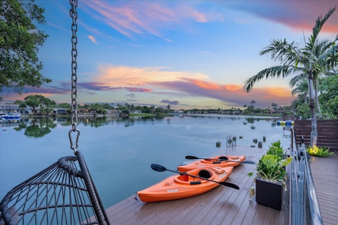 Paddle out across the glassy lake as the sky turns gold