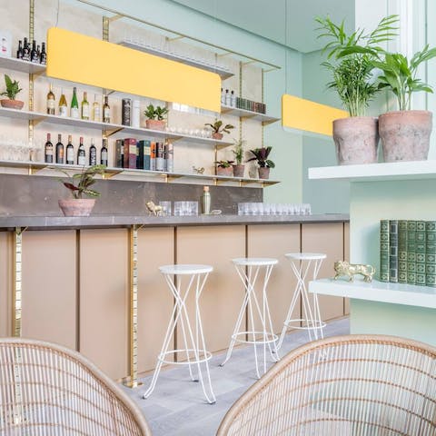 Unwind at the bar downstairs with a drink before dinner