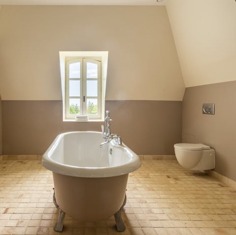 Sink into the free-standing bath tub with a view overlooking the rolling countryside