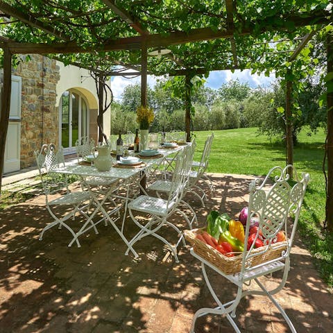 Dine alfresco under the vine-covered pergola